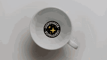 a cup of coffee with a logo that says introverts