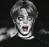 a black and white photo of a person with a scary face painted on their face .
