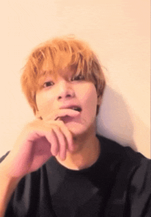 a close up of a person with their hand on their chin