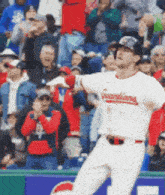 a baseball player wearing a guardians jersey is swinging at a ball