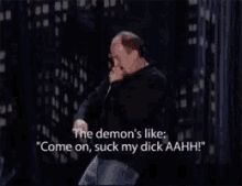 a man is holding a microphone and saying " the demon 's like "