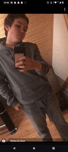 a person taking a selfie with the time of 18:48 on the bottom