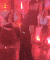 a man in a black shirt is standing in front of a sign that says ' a '