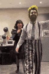 a man with a beard and suspenders dancing with a woman