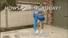 a man and a woman are running down a sidewalk in front of a garage .