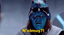 a man with blue paint on his face is saying n'olmus !