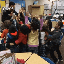 a group of children are giving each other high fives in a classroom with the words crys on the bottom