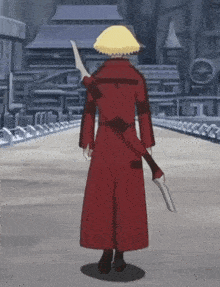 a man in a red coat holds a sword in his right hand