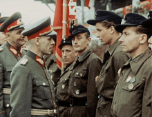 a group of men in military uniforms are standing in a line