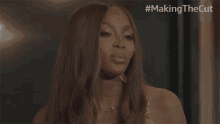 a close up of a woman 's face with the hashtag #making the cut above her