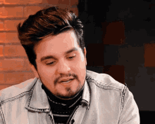 a man with a beard wearing a white jacket
