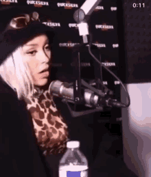 a woman is sitting in front of a microphone in a radio station .