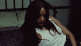 a woman with red hair and a nose ring is laying on a bed