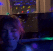 a blurry picture of a person smoking a cigarette in a dark room .