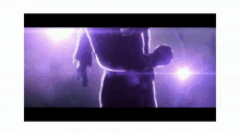 a purple light is shining on a person 's back