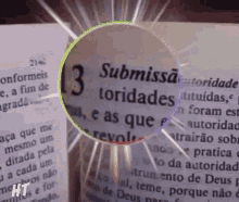 a magnifying glass shows the word submissa on a page of a book