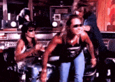 a group of men are standing in a room with a woman behind them .