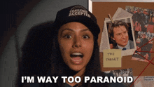 a woman wearing a hat that says challenge accepted stands in front of a bulletin board