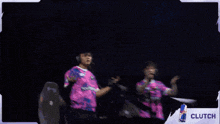 two people dancing in front of a screen that says clutch on it