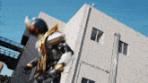 a man in a superhero costume is running in front of a building