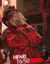 a man with a tattoo on his arm is covering his face with his hands in front of a henri 16/50 sign