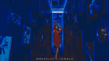 a woman in a red dress is standing in a blue hallway with whereluv tumblr written on the bottom