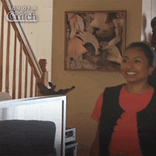 a girl is smiling in front of a painting titled son of a glitch