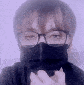 a person wearing glasses and a face mask