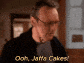a man with glasses says " ooh jaffa cakes " in yellow letters