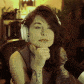 a woman with headphones and a tattoo on her arm