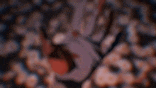 a close up of a person 's hand with blood on it and a blurry background .