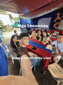 a group of people sitting at a table with the words happy 1st birthday liam written on the bottom