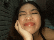 a woman making a funny face with her hand on her chin