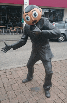 a statue of a man with a cartoon face on his head