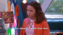 a girl in an orange jacket is saying you deserve better than that