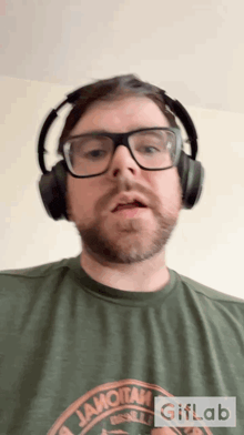 a man wearing headphones and a t-shirt that says iamotan