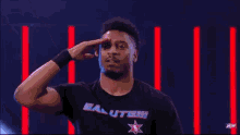 a wrestler wearing a black shirt that says salute