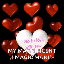 a white heart is surrounded by red hearts with the words `` so in love with you my magnificent magic man '' written on it .