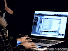 a person is typing on a laptop that says [ detective lives discord ] on the screen