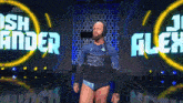 a man in a wrestling outfit is standing in front of a sign that says ' ash finder ' on it