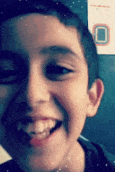 a close up of a boy 's face with the letter o in the corner