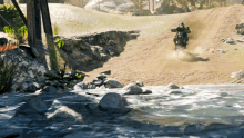 a person riding a motorcycle on a dirt road next to a body of water