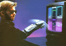 a man wearing sunglasses and a glove is playing a video game