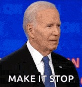 a man in a suit and tie is standing in front of a blue background and says `` make it stop '' .
