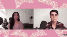 a man and a woman are sitting next to each other in front of microphones .