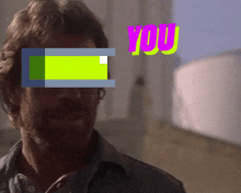 a man with a yellow square in his eye and the word you in pink