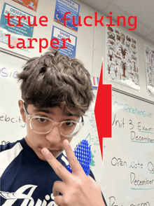a boy in front of a white board that says unit 3 exam