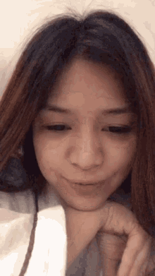 a close up of a woman 's face with her hands on her face