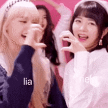 a group of girls are standing next to each other laughing and making funny faces .