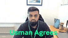 a man sitting at a desk with the words usman agrees on the bottom